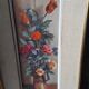 Pair of framed paintings featuring a composition of flowers.