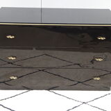 Lacquered black chest of drawers, golden brass