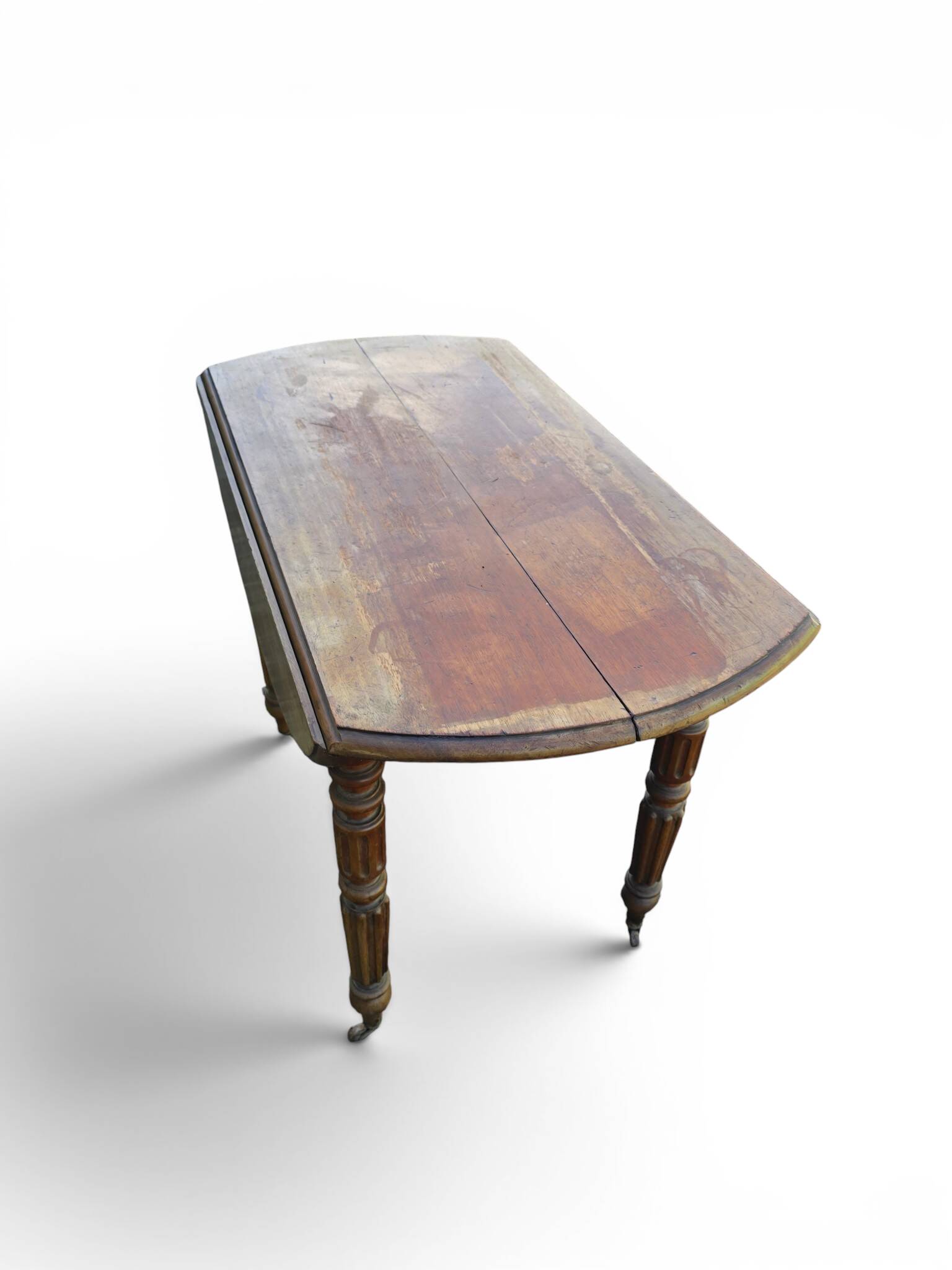 Antique drop-leaf table in wood, with turned legs and castors.