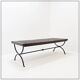 Solid wood coffee table with an openwork design and wrought iron legs.