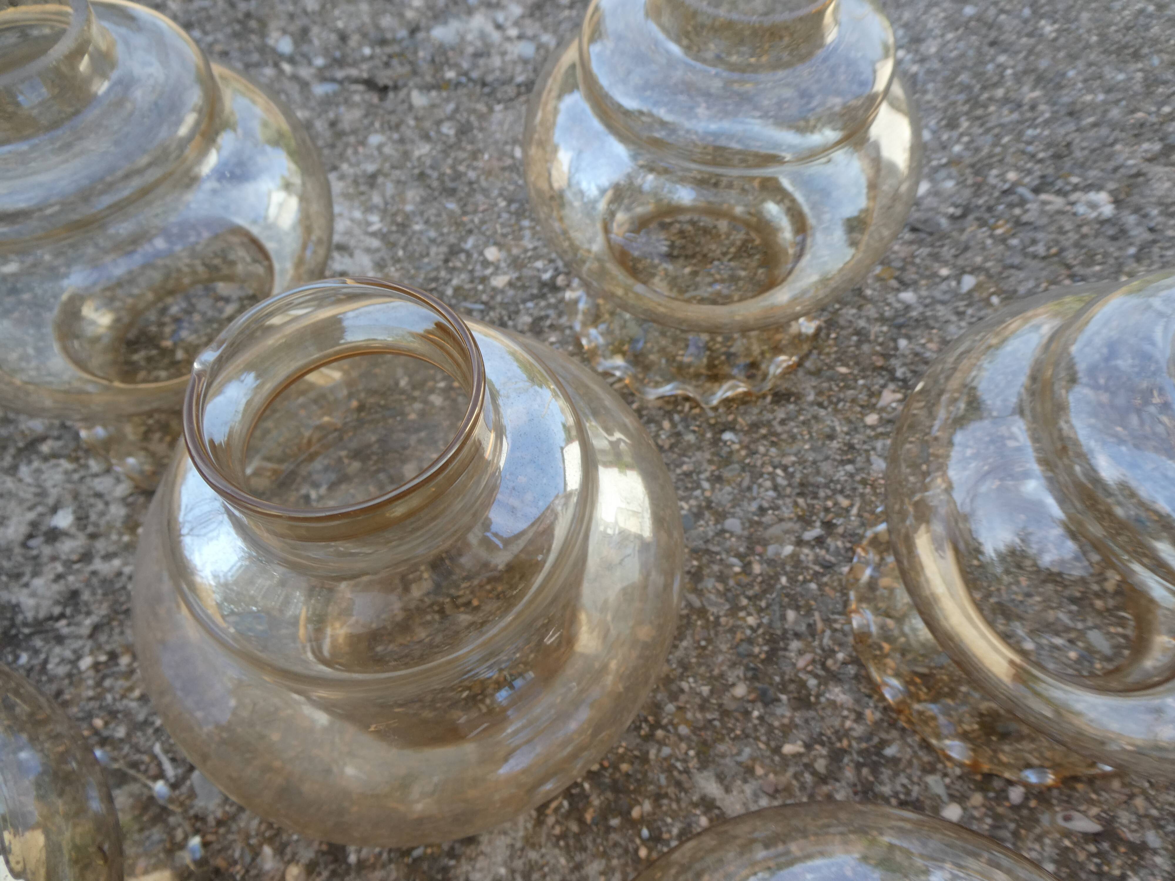 Set of 6 amber glass globes.