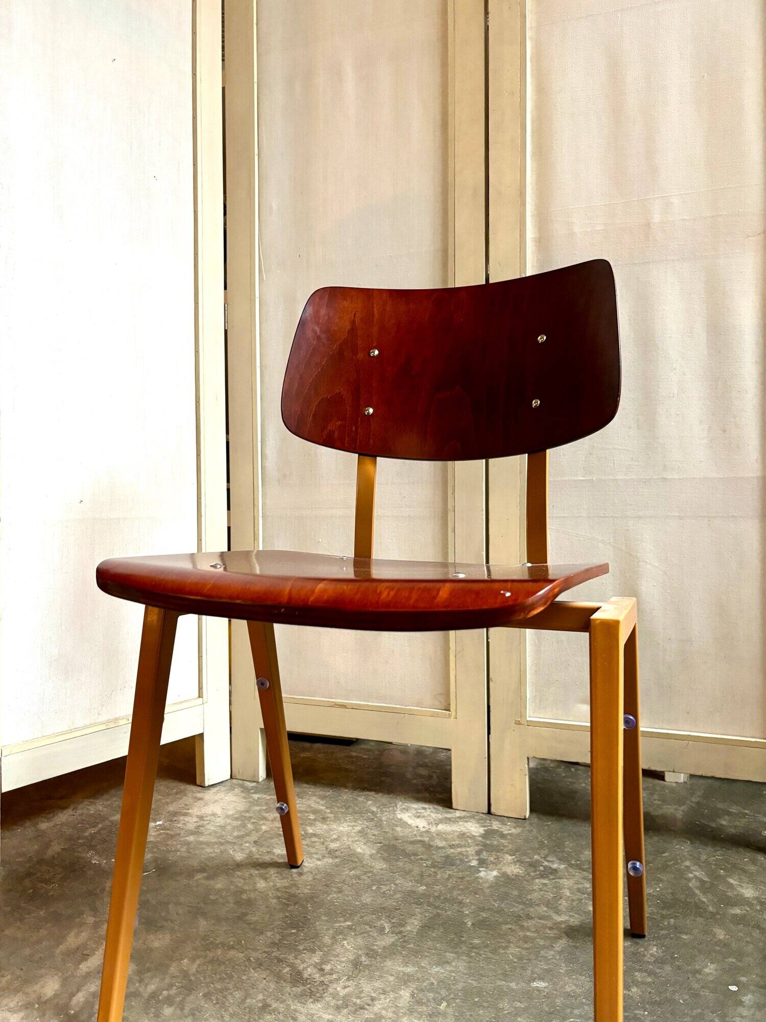 Chair in dark wood and ocher metal