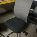 Vitra ID Trim office chair by Antonio Citterio — black mesh backrest and blue fabric seat, aluminium frame.