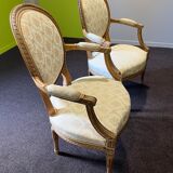 Pair of Louis XVI style armchairs, in solid walnut, re-edged and upholstered, pegged