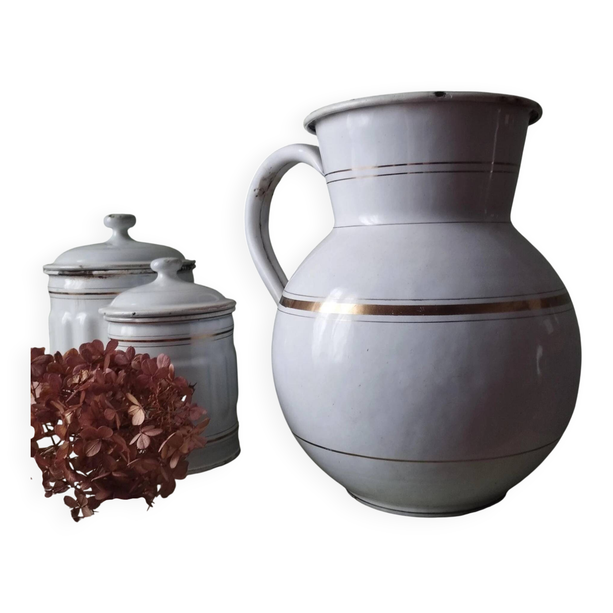 Old enamelled metal jug with gold trim.