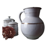 Old enamelled metal jug with gold trim.