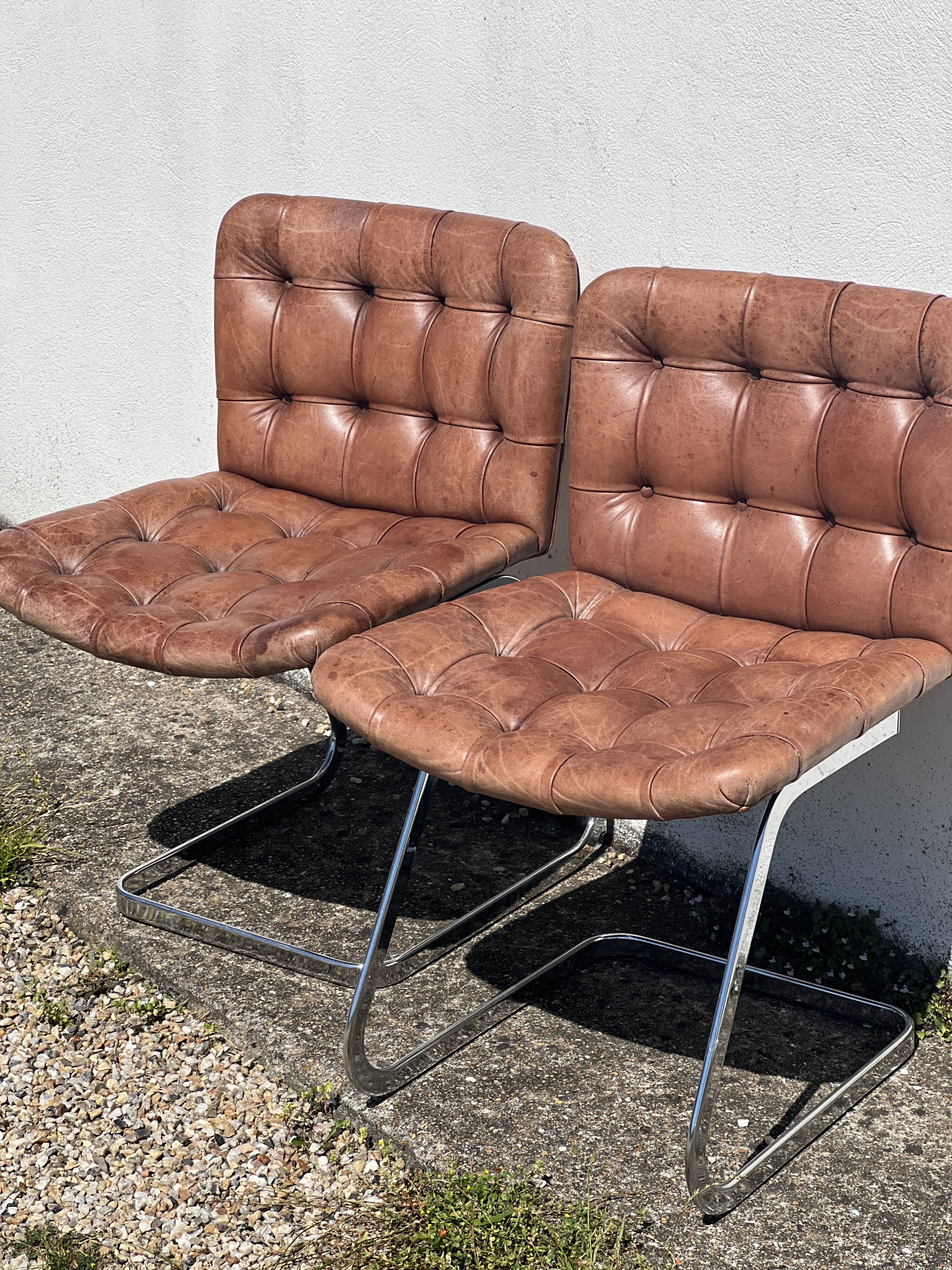 Pair of leather chairs by Robert Haussman