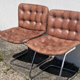 Pair of leather chairs by Robert Haussman