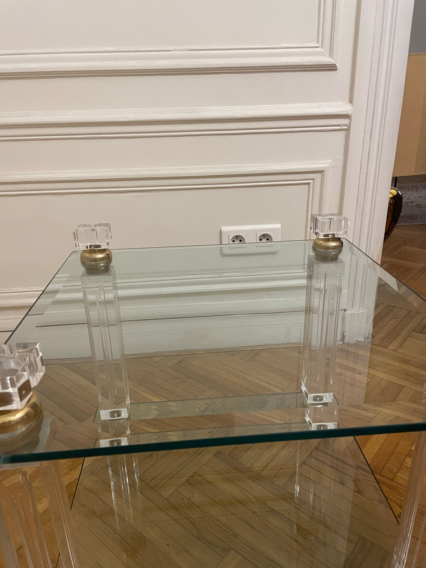 Glass side table with gold decorations.