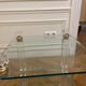 Glass side table with gold decorations.