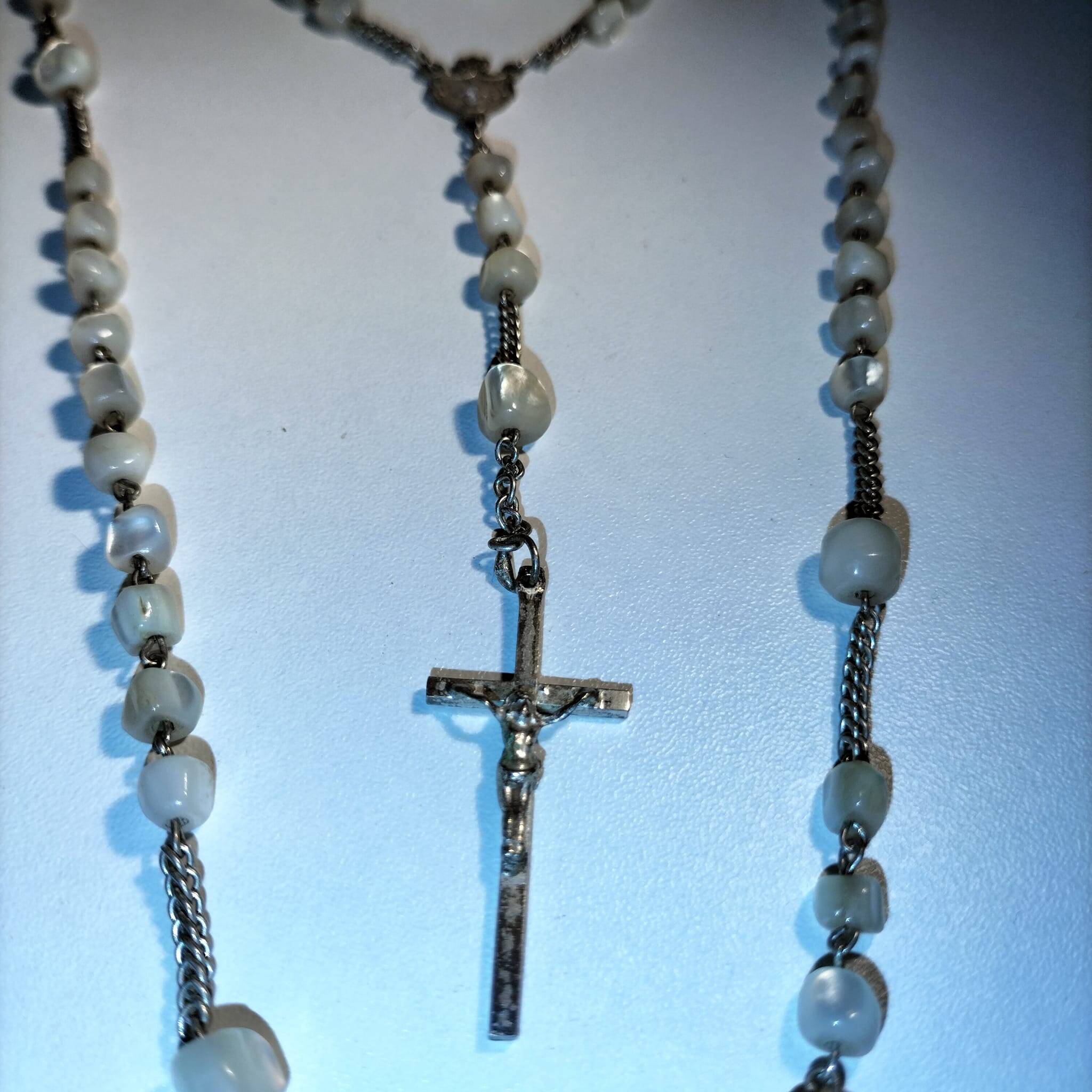 Old mother-of-pearl rosary in its egg box