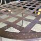 Old wrought iron table and its armchairs and chairs for outdoor use.