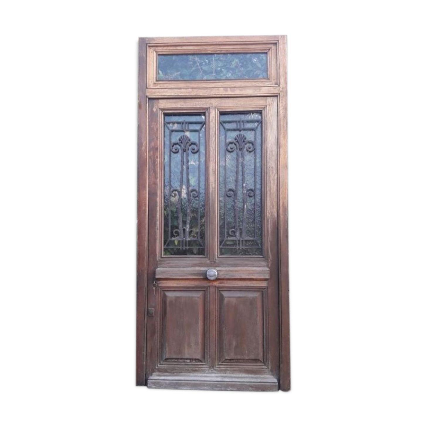 Oak entrance door and its frame and transom, wrought iron gates