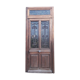 Oak entrance door and its frame and transom, wrought iron gates