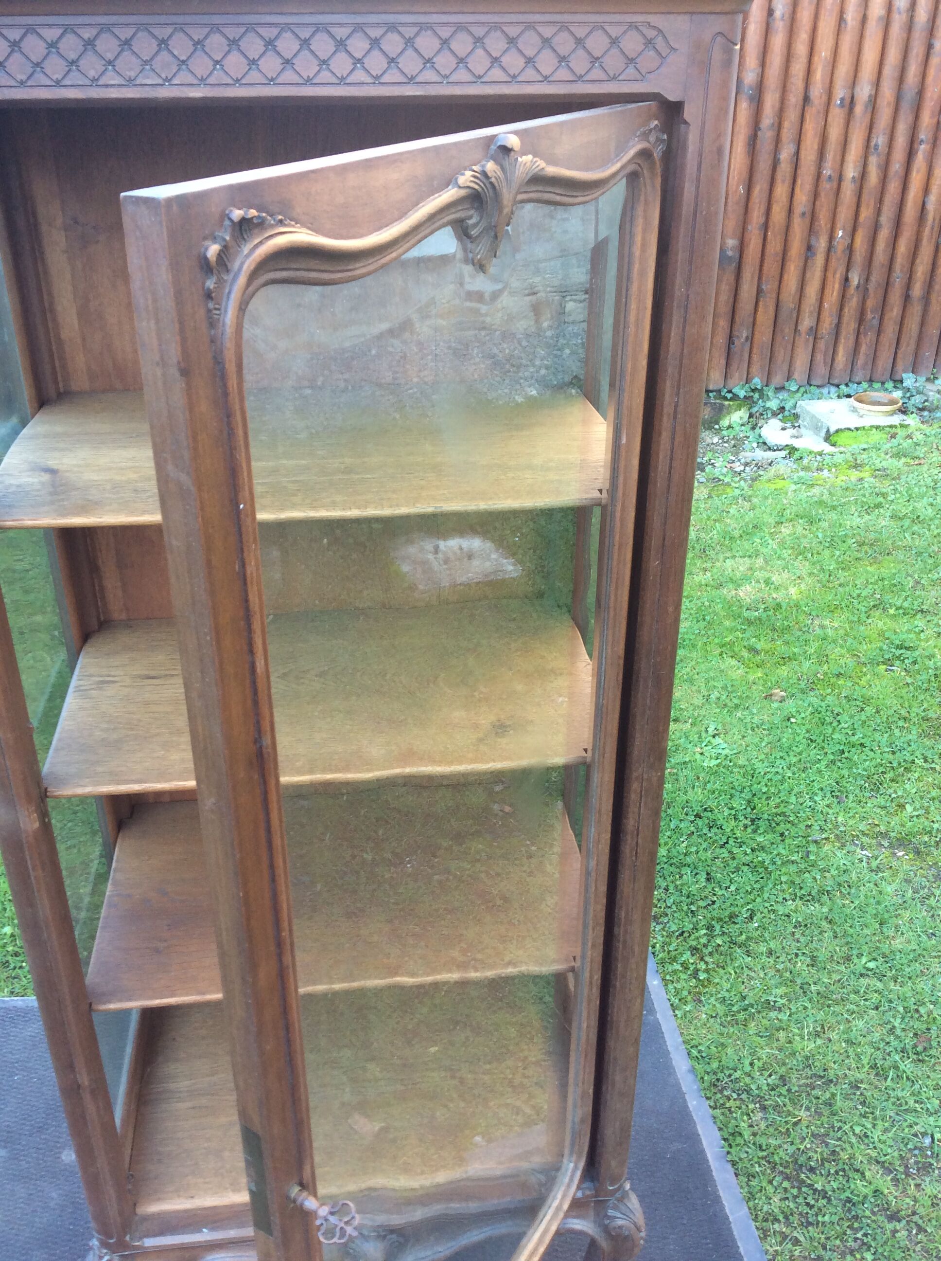 Louis XV Rocaille style showcase in solid walnut, beveled door glass.