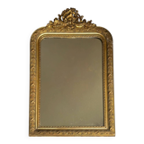 Golden mirror with a pediment from the early 20th century.