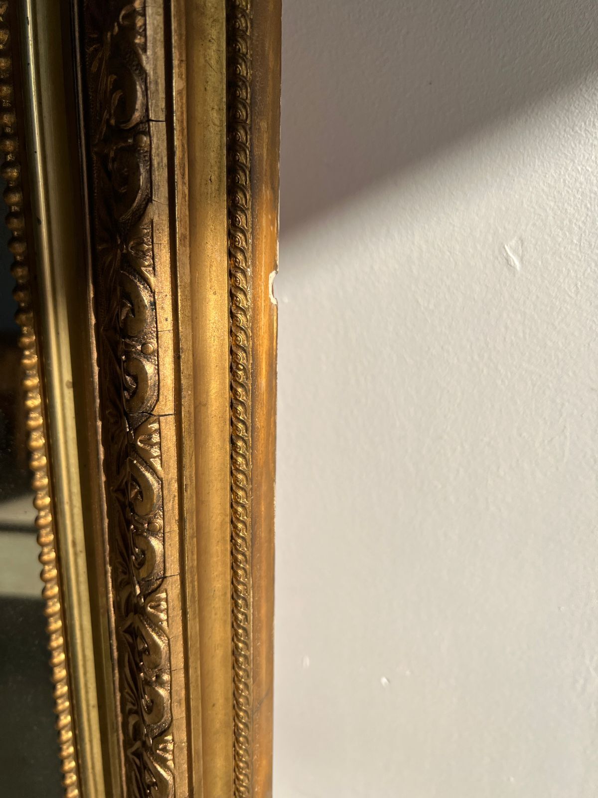 Gilded mirror with frieze h2m10 l:73cm