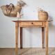 Small old farmhouse table in raw wood.
