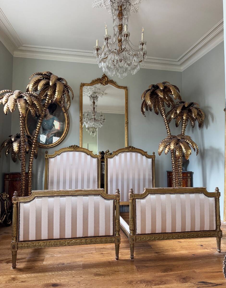 Pair of late 19th-century gilded wooden beds in Louis XVI style.