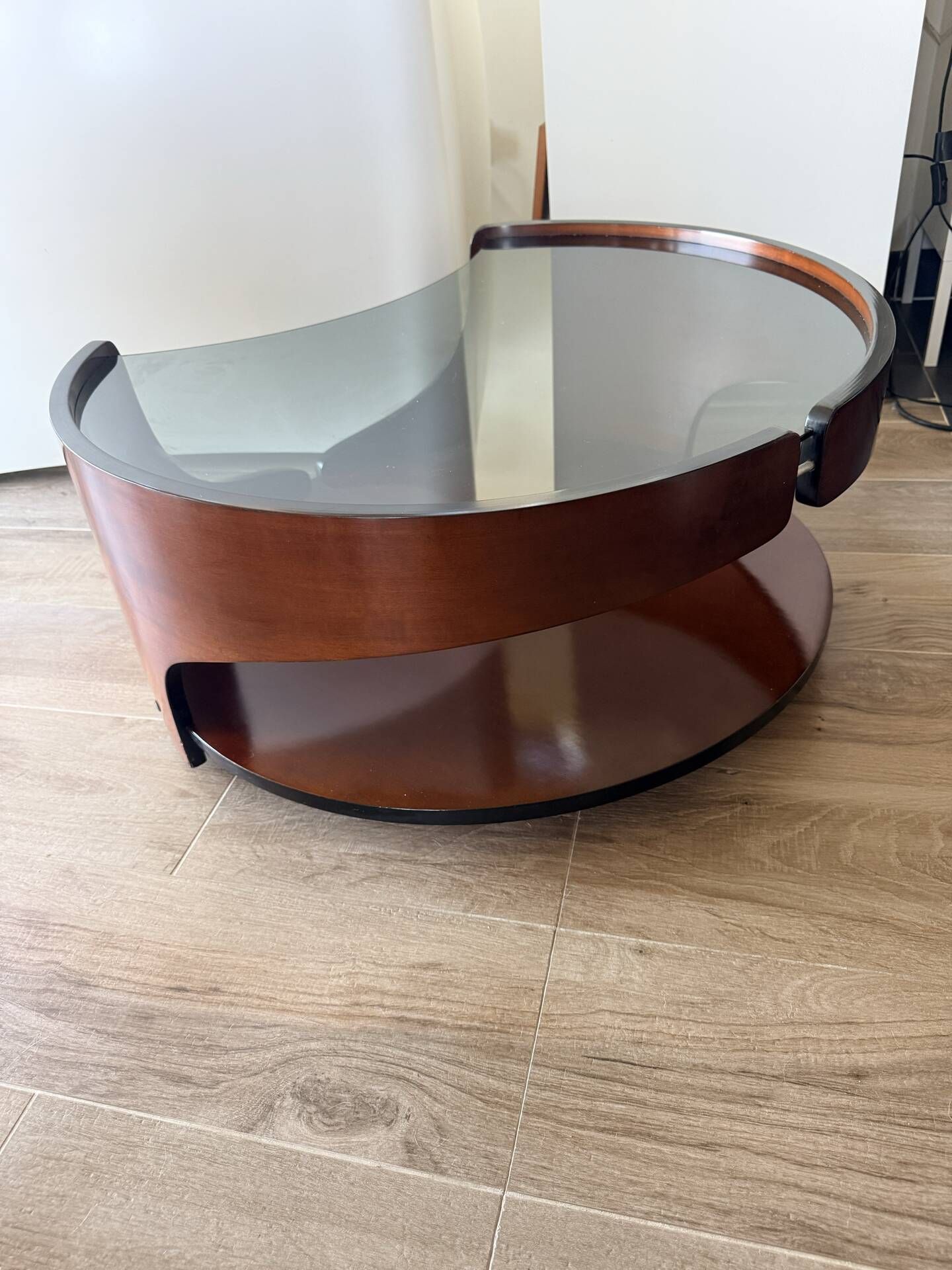 Italian Space Age coffee table in curved wood and smoked glass – 1970s