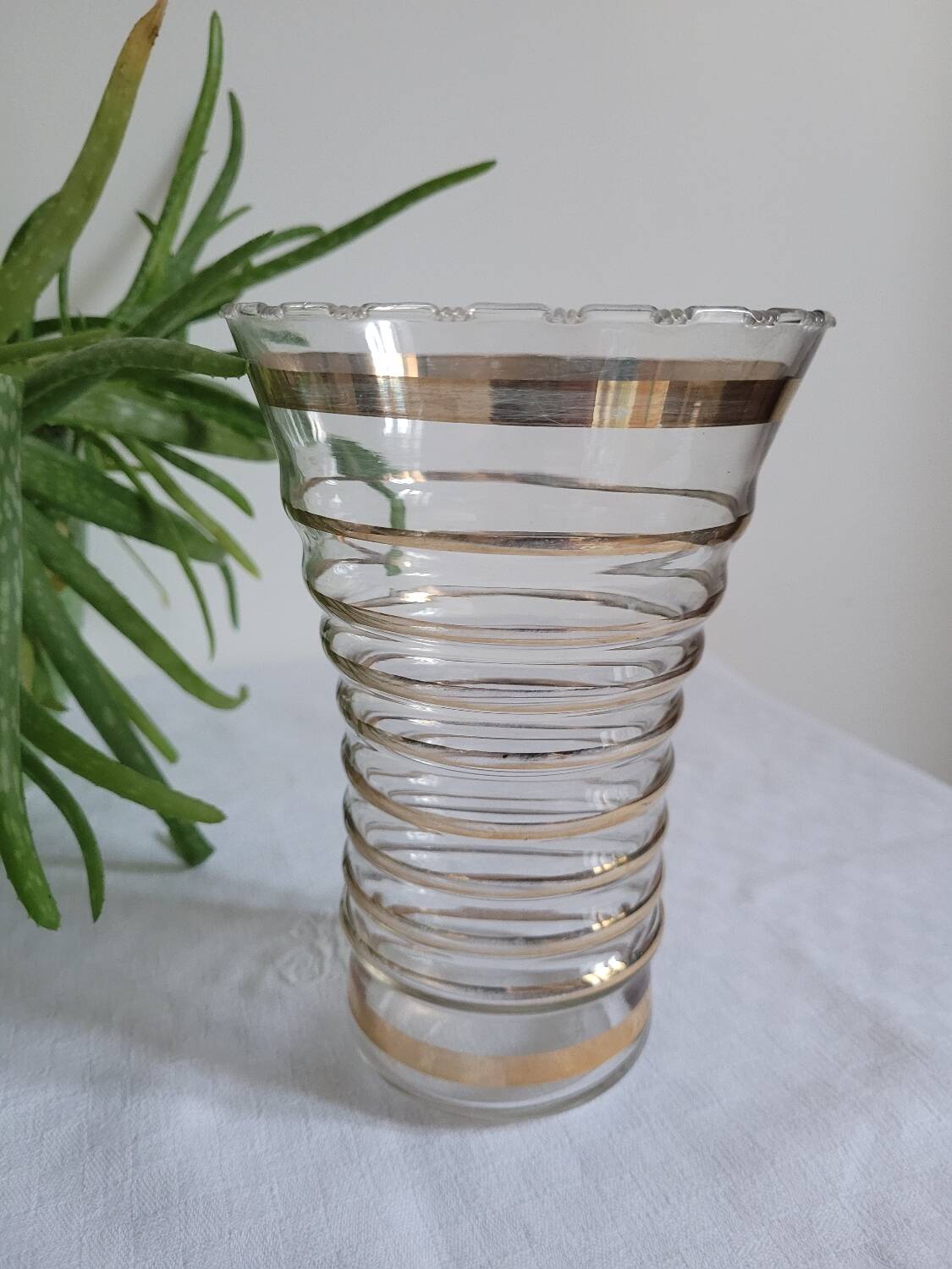 Vase with golden trim and lace-edged rim.