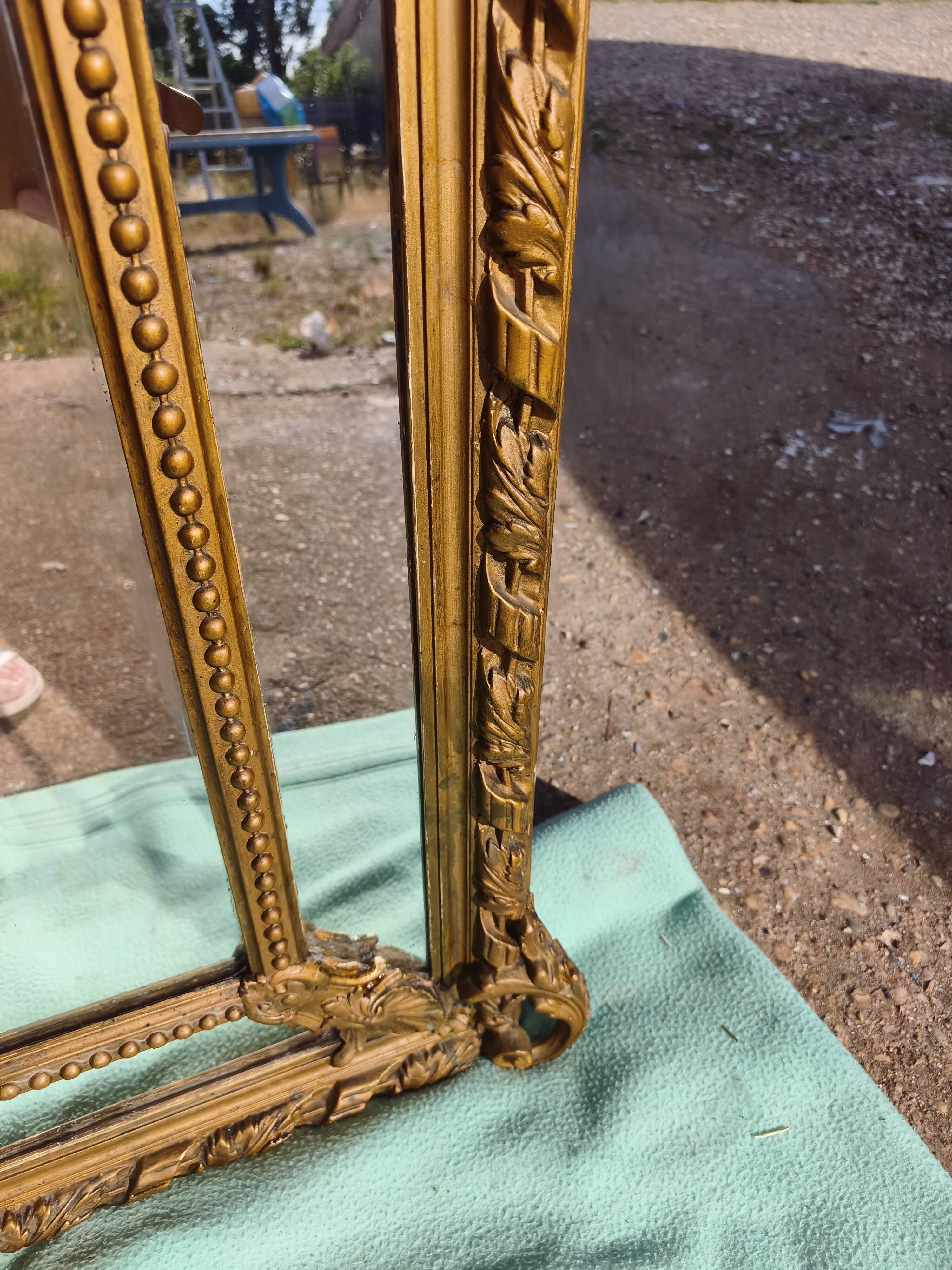 Large closed mirror, 19th century, wood and gilded stucco.
