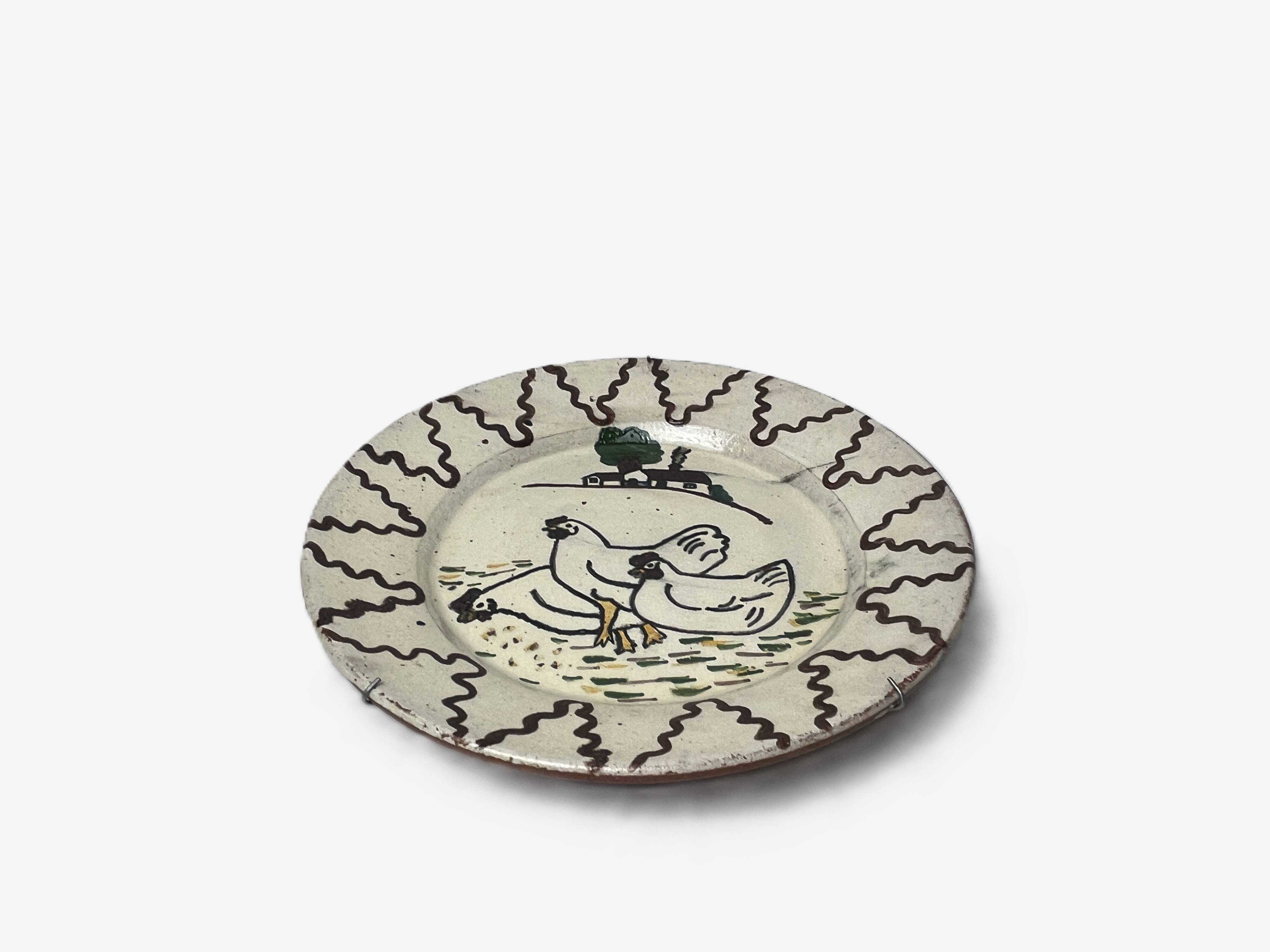 Old terracotta plate decorated with chickens, Portugal, 20th century.
