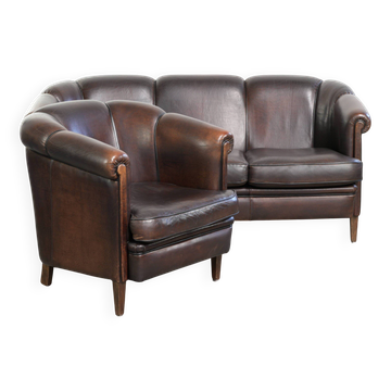 Set of a sheepskin sofa together with its matching club armchair