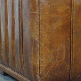 Cognac-colored cowhide 2-seater designer sofa finished with piping