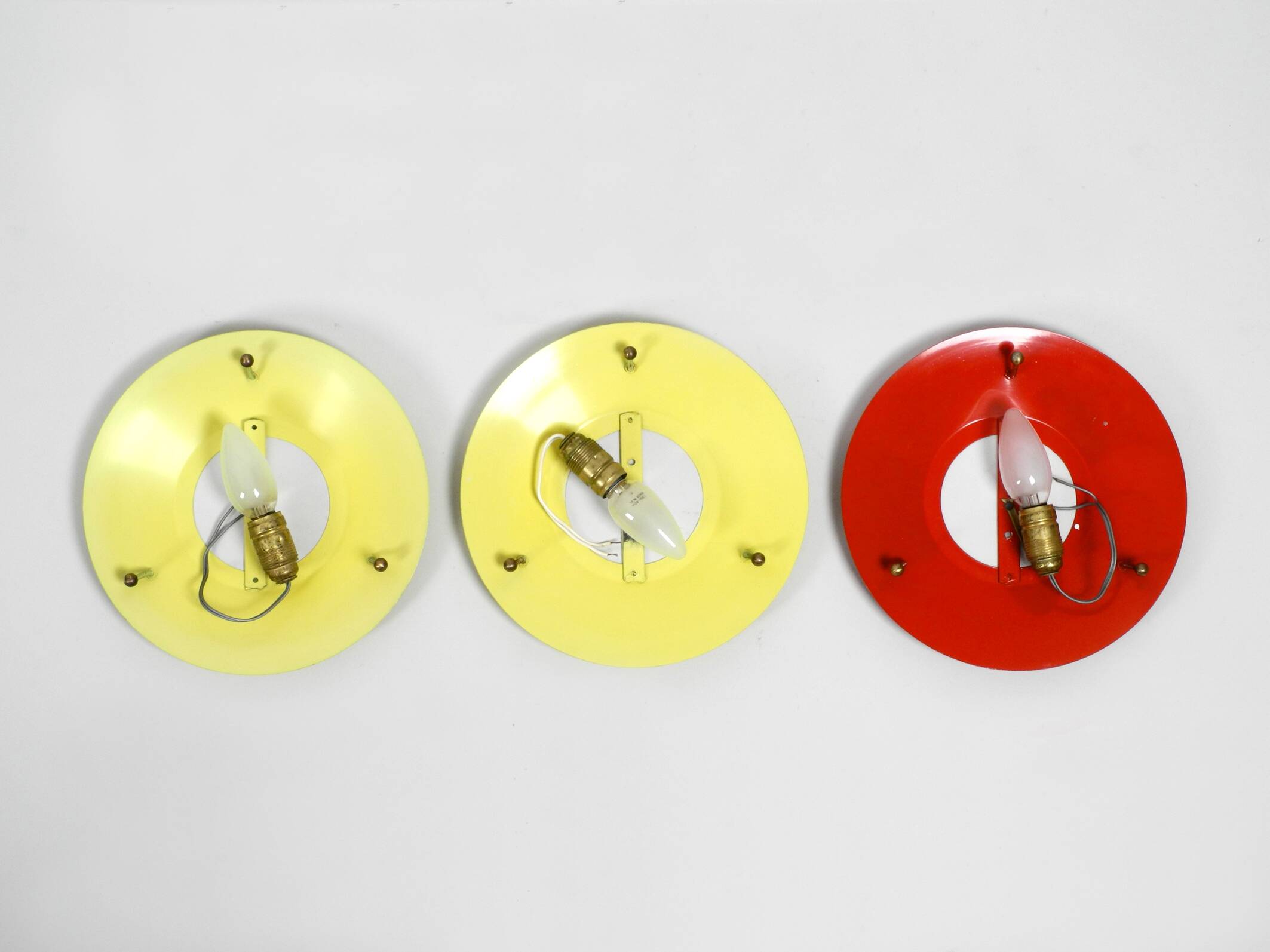 Three round 1950s wall or ceiling lamps made of metal and plexiglass shades