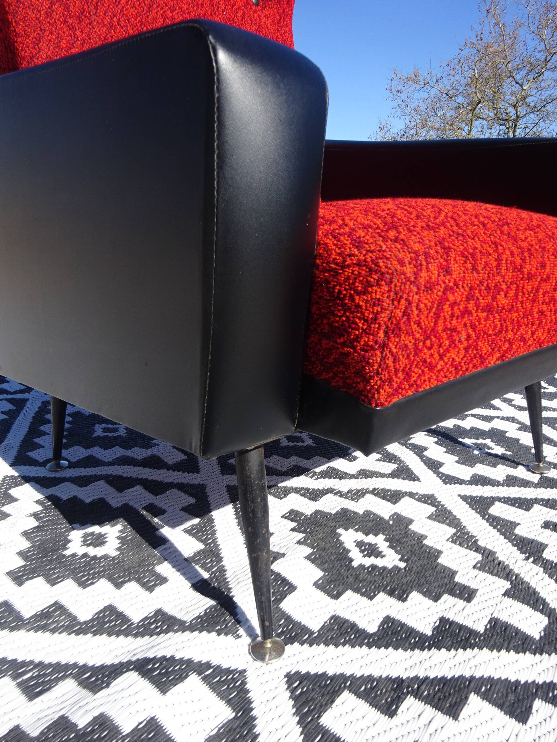 Vintage armchairs in red and black faux leather, the pair.