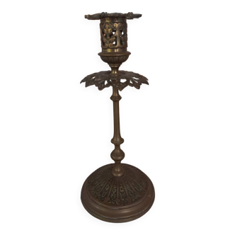 Old candlestick with chiseled bronze collar