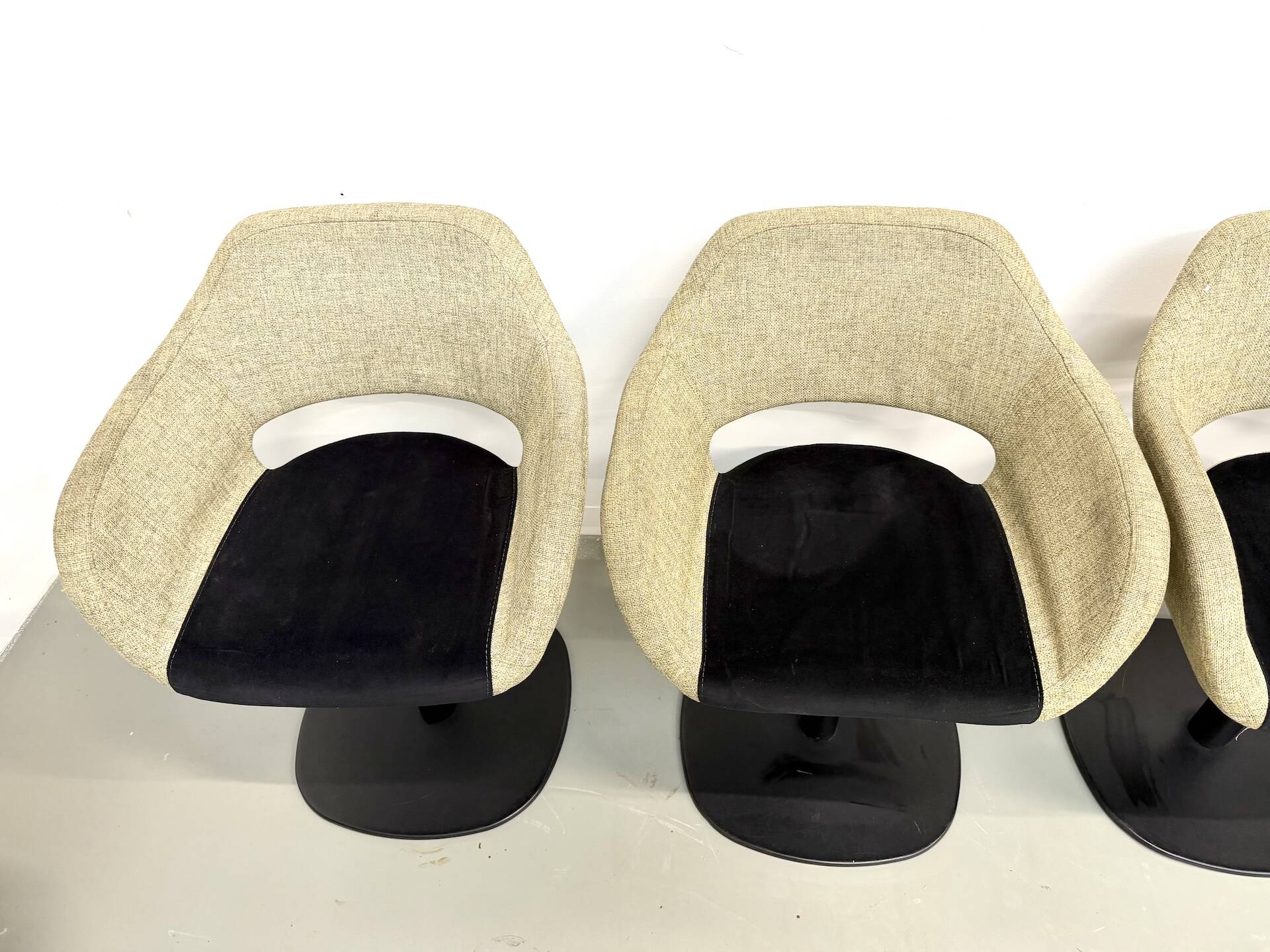 Series of six swivel chairs with an organic shell, patterned fabric and base.