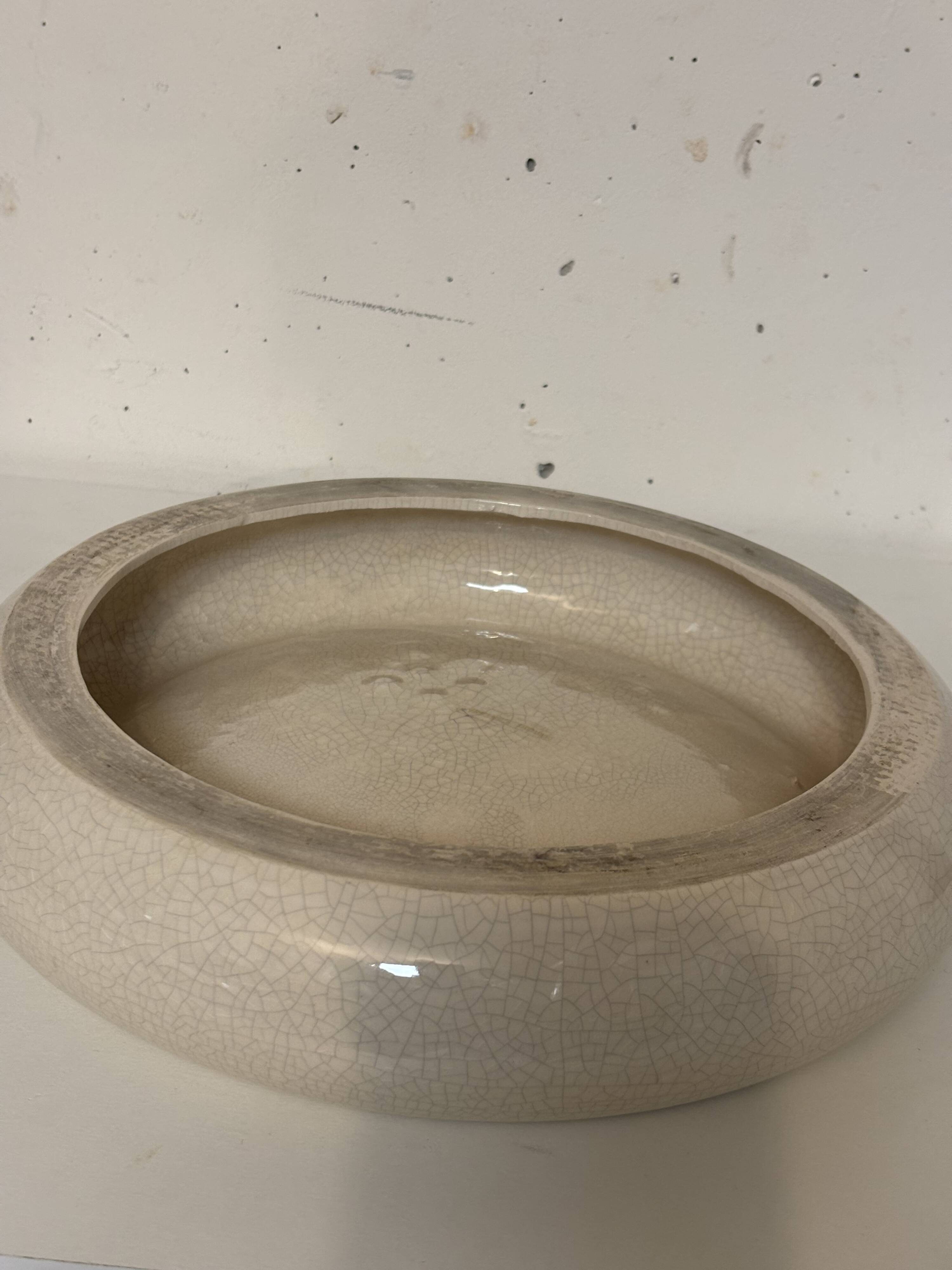 Empty pocket, cracked ceramic dish 1980