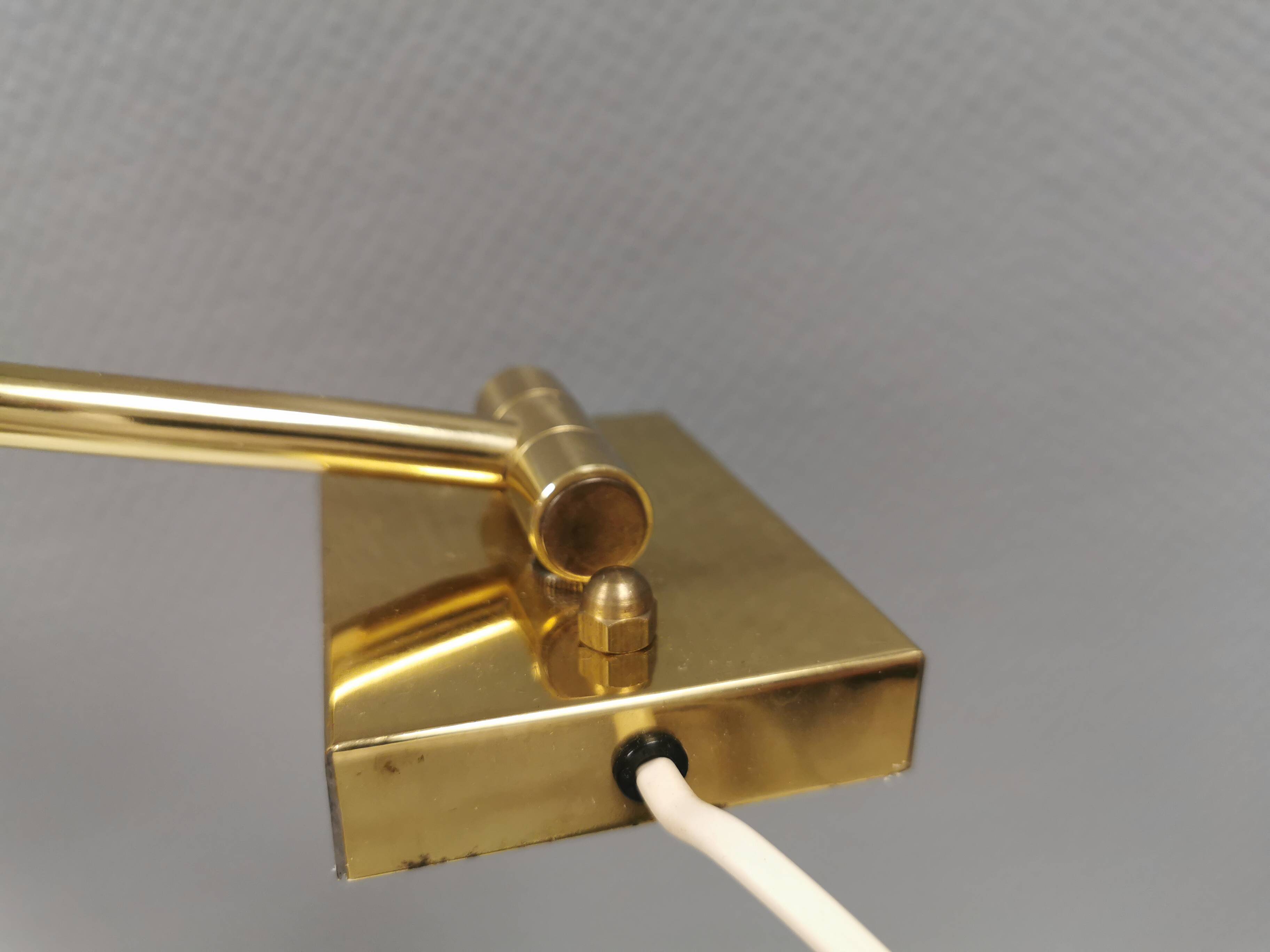 Danish Brass wall lamp with a ‘swivel’ effect.