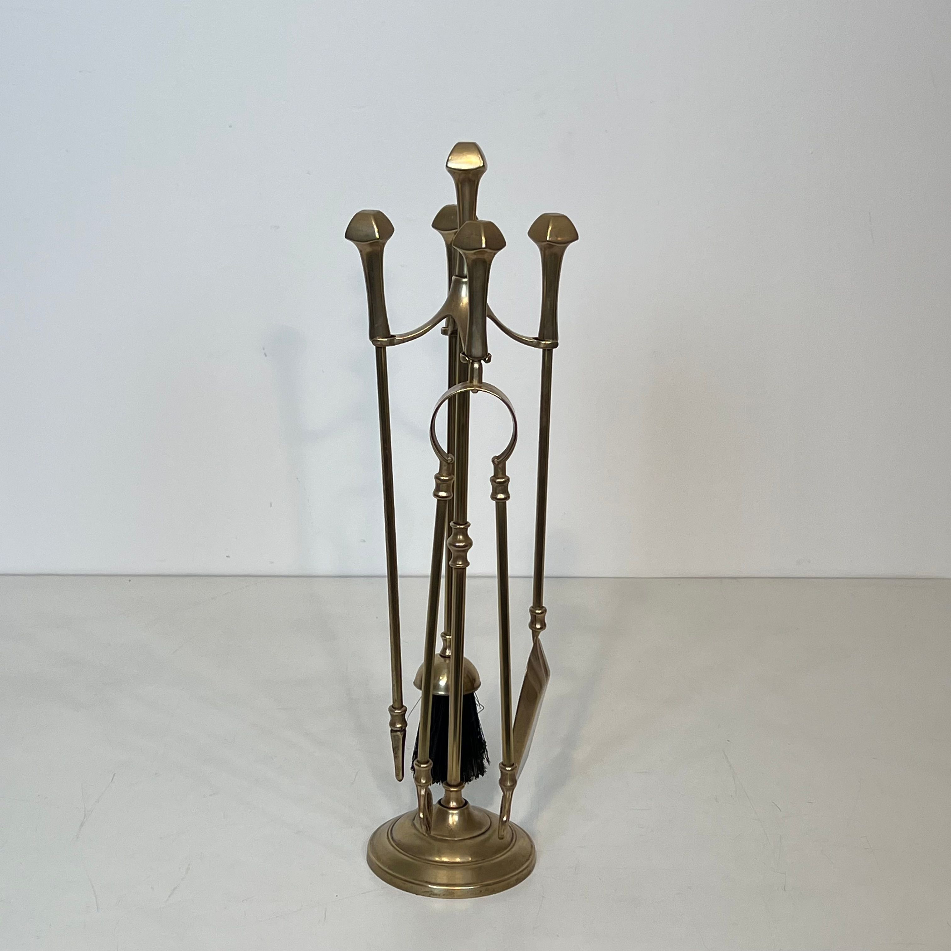 Neoclassical brass fire accessory.