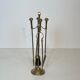 Neoclassical brass fire accessory.