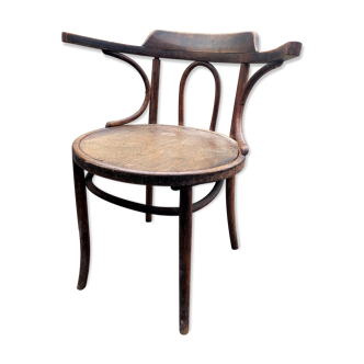 Curved wooden armchair of office bistro Fischel