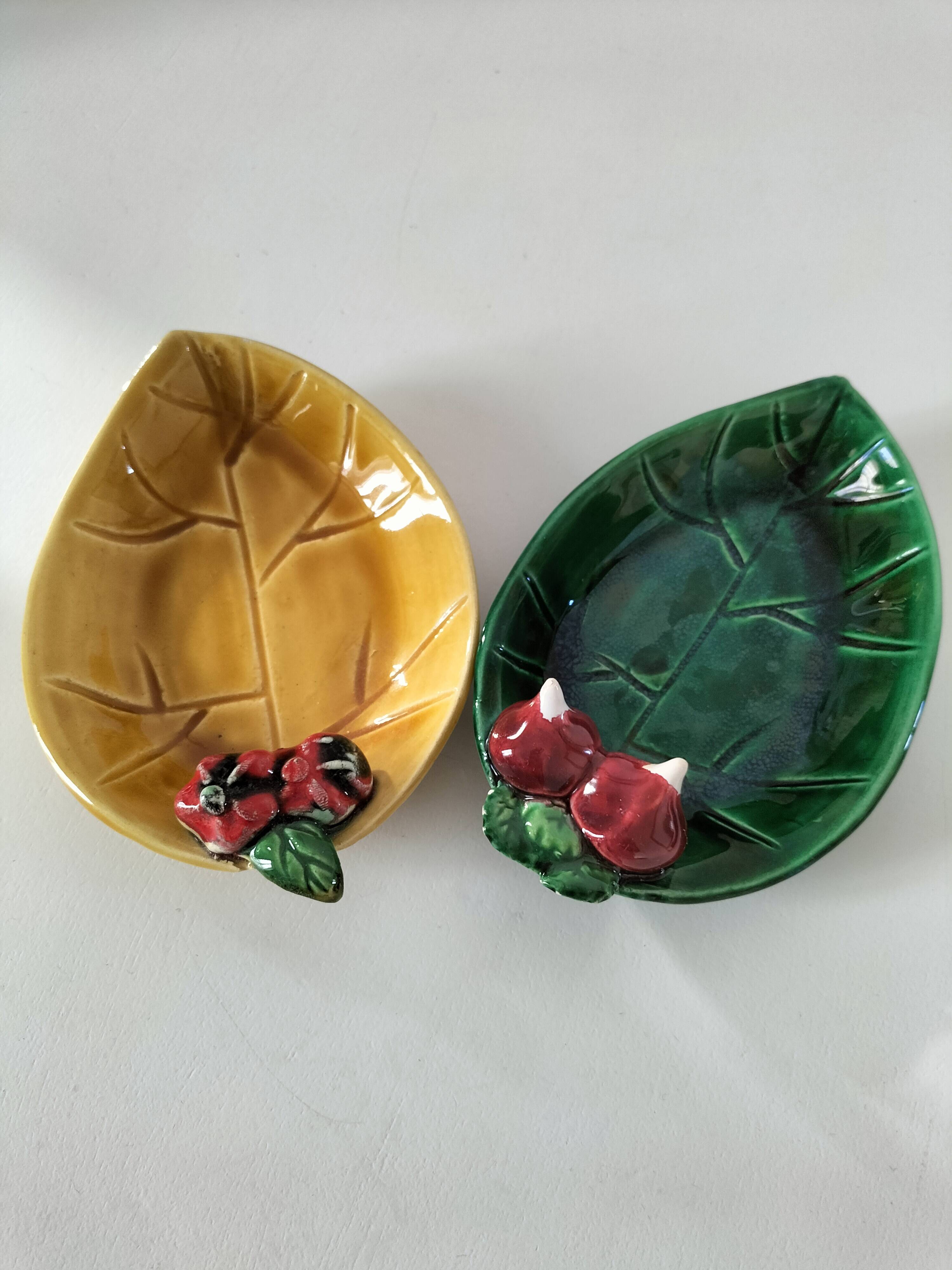 Two relief bowls with leaf designs, radishes, and tomatoes.