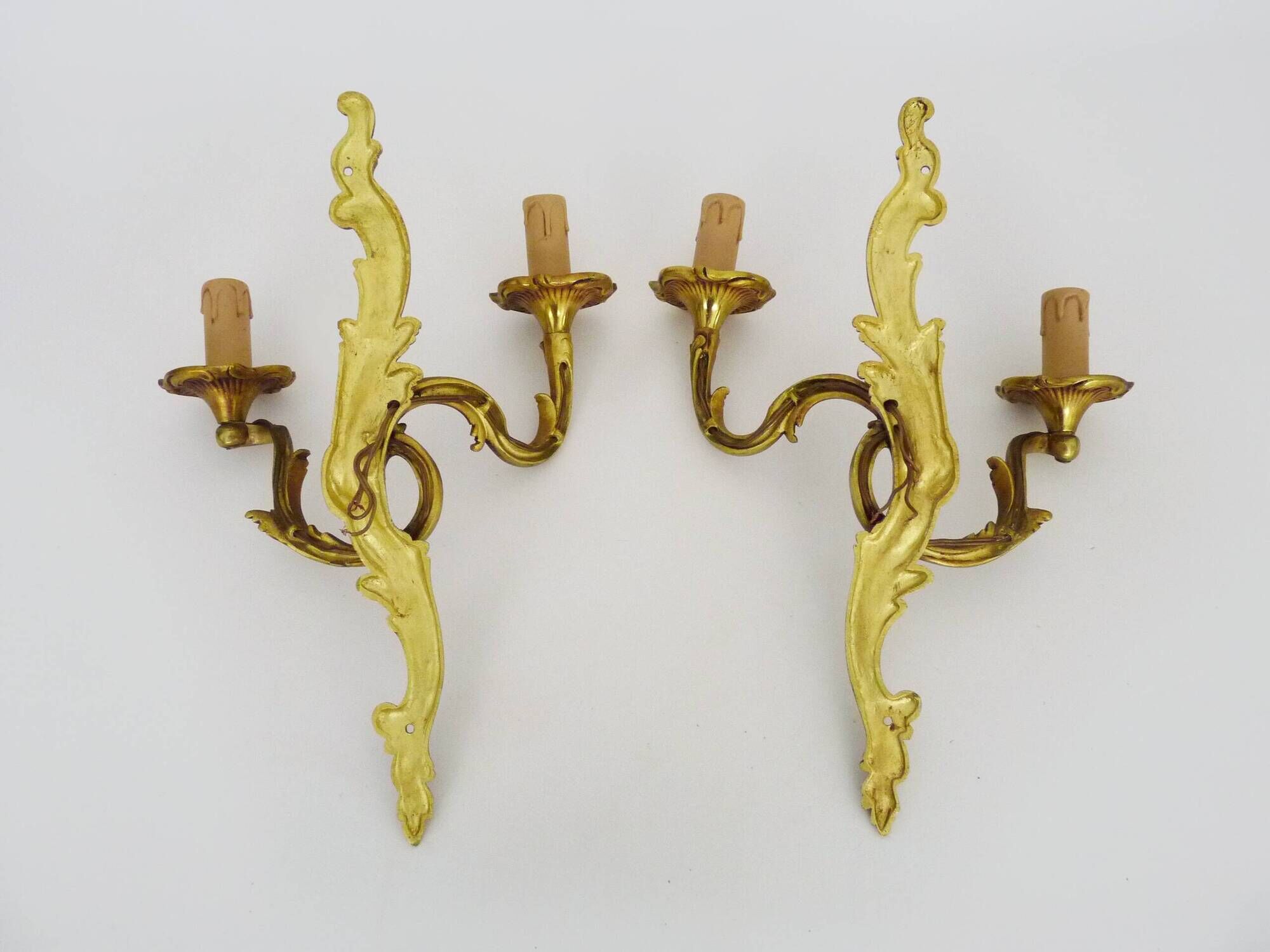Antique pair of double-light bronze wall sconces with acanthus leaves. 1950s