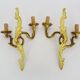 Antique pair of double-light bronze wall sconces with acanthus leaves. 1950s