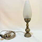 Old bronze or brass table lamp from the early 20th century with white streaked flame glass globe