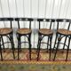 Suite de 4 tabourets de bar en cannage et bois noirci