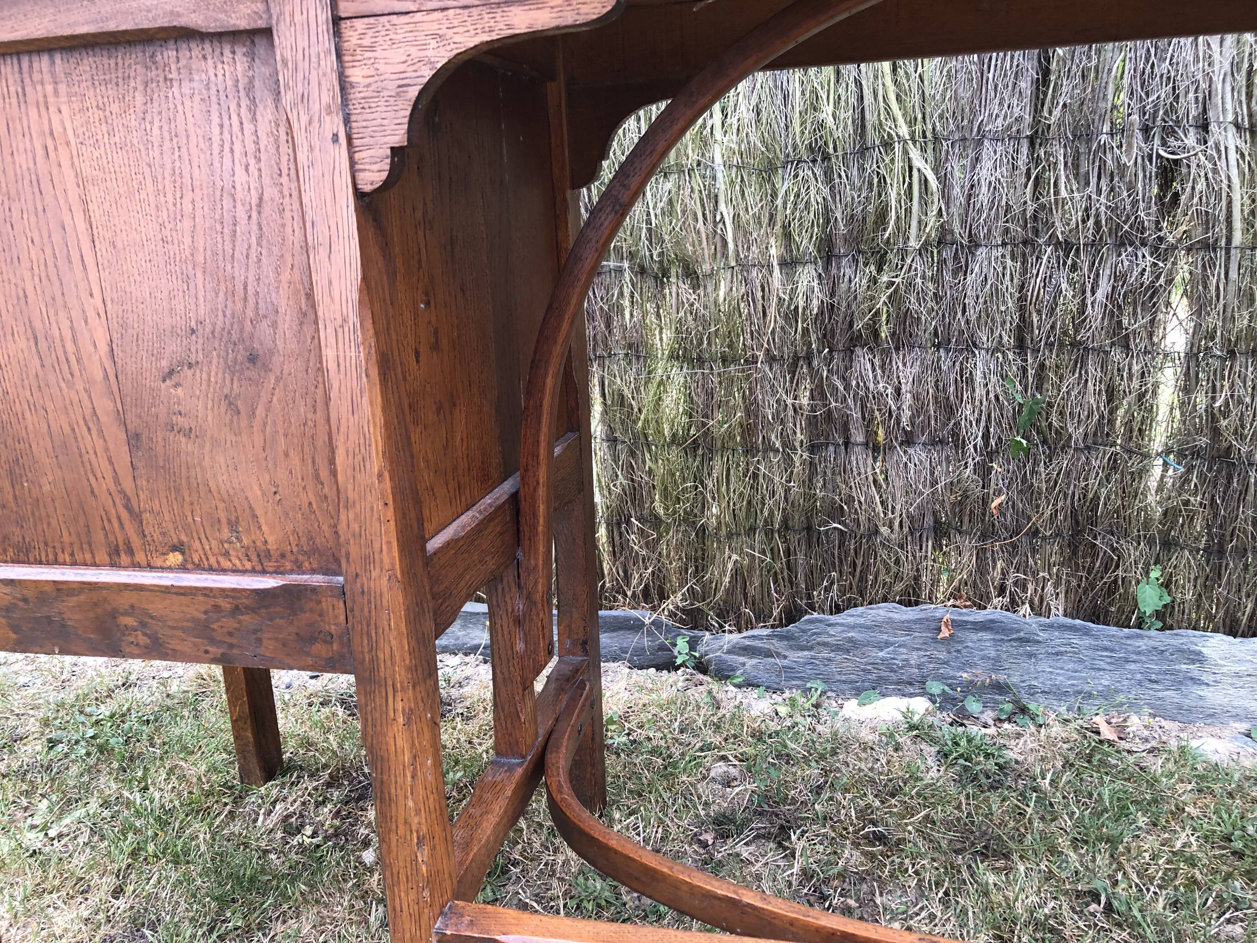 Old oak desk with curved wooden sleepers in the Art Nouveau spirit of the early 20th century.