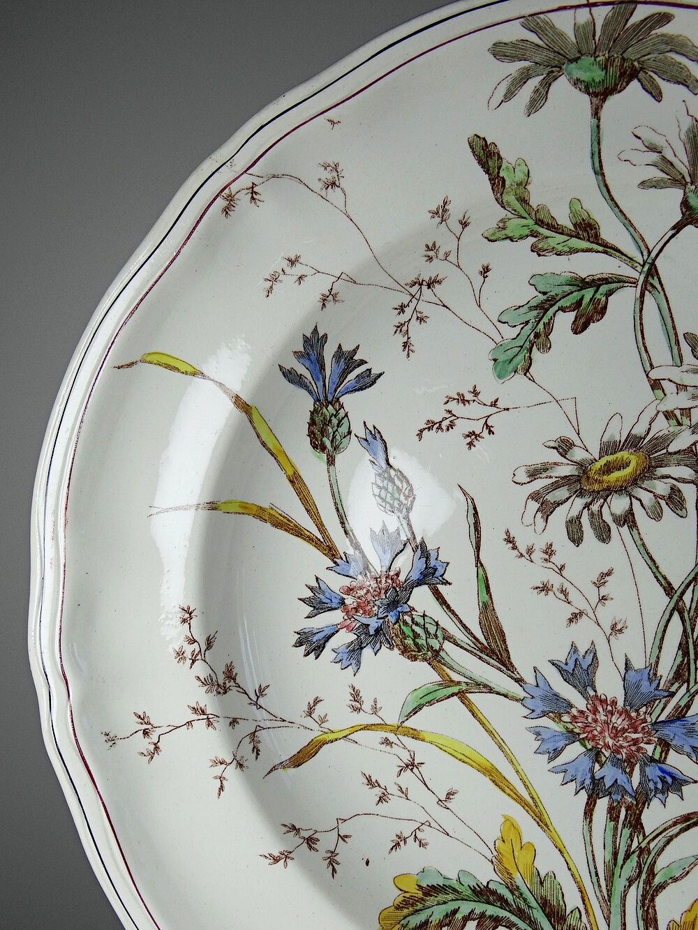 Antique Longchamp shallow dish with polychrome daisies in ironstone.