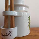 Vintage porcelain pickle pot with wooden pliers.