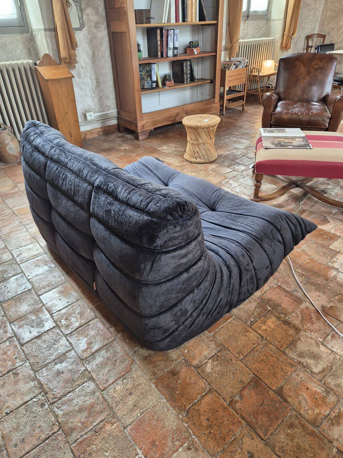 Togo sofa by Ligne Roset and its pouf from the 1970s.