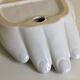 Empty white enamelled ceramic pocket in the shape of a large hand, 1990