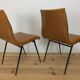 Pair of 1950s chairs with compass legs and brown faux leather.