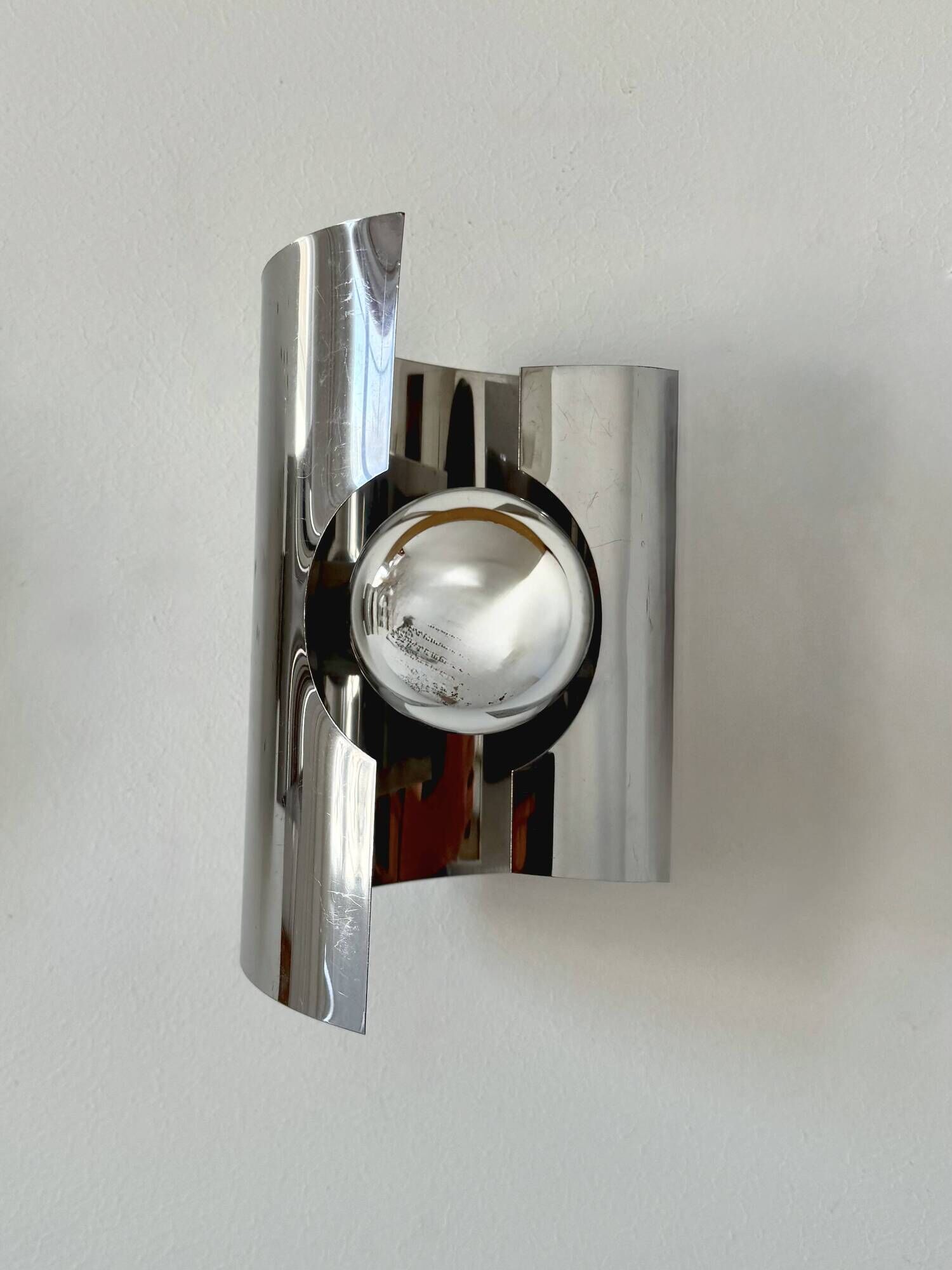 Pair of vintage wall lights, curved chrome metal, France, 1970.